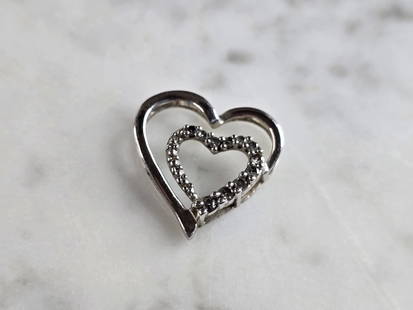 Womens Vintage Estate 10K White Gold Heart Diamond Pendant: A WOMENS VINTAGE ESTATE 10K WHITE GOLD DIAMOND HEART PENDANT. THE PENDANT WEIGHS 1.1g, AND MEASURES 5/8" LONG BY 5/8" WIDE. THERE ARE ABOUT .11cts OF DIAMONDS. PENDANT IS MARKED ON THE BACK. 
