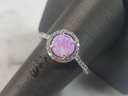 Womens Vintage Estate Sterling Silver Pink Opal Stone Ring: A WOMENS ESTATE STERLING SILVER PINK OPAL STONE RING. NOT SURE IF STONES ARE REAL OR MAN MADE. THE RING WEIGHS 2.7g AND IS A SIZE 7.5. FACE MEASURES 3/8". MAKES A GREAT GIFT FOR THAT SOMEONE