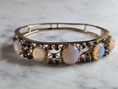 Womens Vintage Estate 14K Gold Opal ? Sapphire Bangle Bracelet: A LOVELY WOMENS VINTAGE ESTATE 14K GOLD BRACELET WITH WHAT APPEARS TO BE OPALS, AND SAPPHIRES. THE BRACELET MEASURES 6 3/4" IN CIRCUMFERENCE, BY ABOUT 1/2" WIDE. AS YOU MAY BE ABLE TO SEE IN THE PICS,