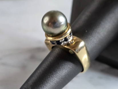 Womens Vintage Estate 14K Gold Pearl & Sapphire Ring: A WOMENS VINTAGE ESTATE 14K GOLD PEARL,SAPPHIRE & DIAMOND RING. THE RING IS A SIZE 6.5, AND WEIGHS 9.4g. NOT SURE IF THE PEARL IS REAL OR MAN MADE. DOES HAVE A GRIT FEELING. RING IS MARKED 14K, JITC.