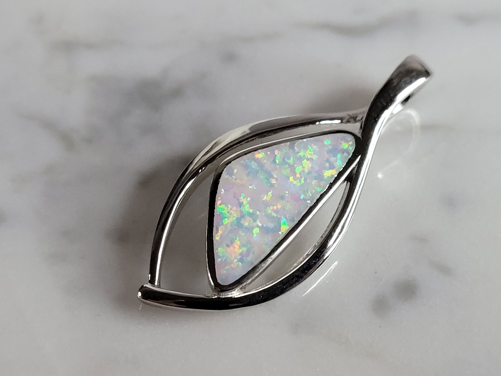 Womens Sterling Silver Opal Modernist Pendant: A WOMENS STERLING SILVER OPAL MODERNIST PENDANT. NOT SURE IF STONES ARE REAL OR MAN MADE. THE PENDANT WEIGHS 4.8g AND MEASURES 1 3/8" LONG BY 1/2" WIDE. MAKES A GREAT GIFT FOR THAT SOMEONE SPECIAL. AN