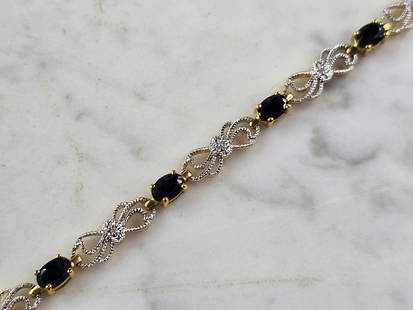 Womens Vintage Estate Sterling Silver Gold Tone Sapphire Bracelet: A WOMENS VINTAGE ESTATE STERLING SILVER GOLD TONE SAPPHIRE COLORED BRACELET . NOTE SURE IF STONE ARE NATURAL OR MAN MADE. BRACELET WEIGHS 10.5g, AND MEASURES 7 1/2" LONG BY 1/4" WIDE. MAKES A GREAT GI