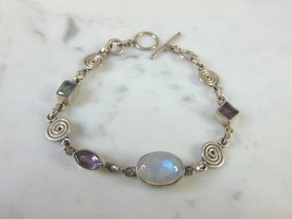 Womens Sterling Silver Tennis Multi Stone Bracelet: FOR SALE IS THIS LOVELY VINTAGE ESTATE STERLING SILVER WOMENS TENNIS BRACELET WITH MULTI COLORED STONES. THE BRACELET MEASURES 7" LONG BY 5/16" WIDE, AND WEIGHS 11.7g. NOT SURE IF THE STONES ARE REAL