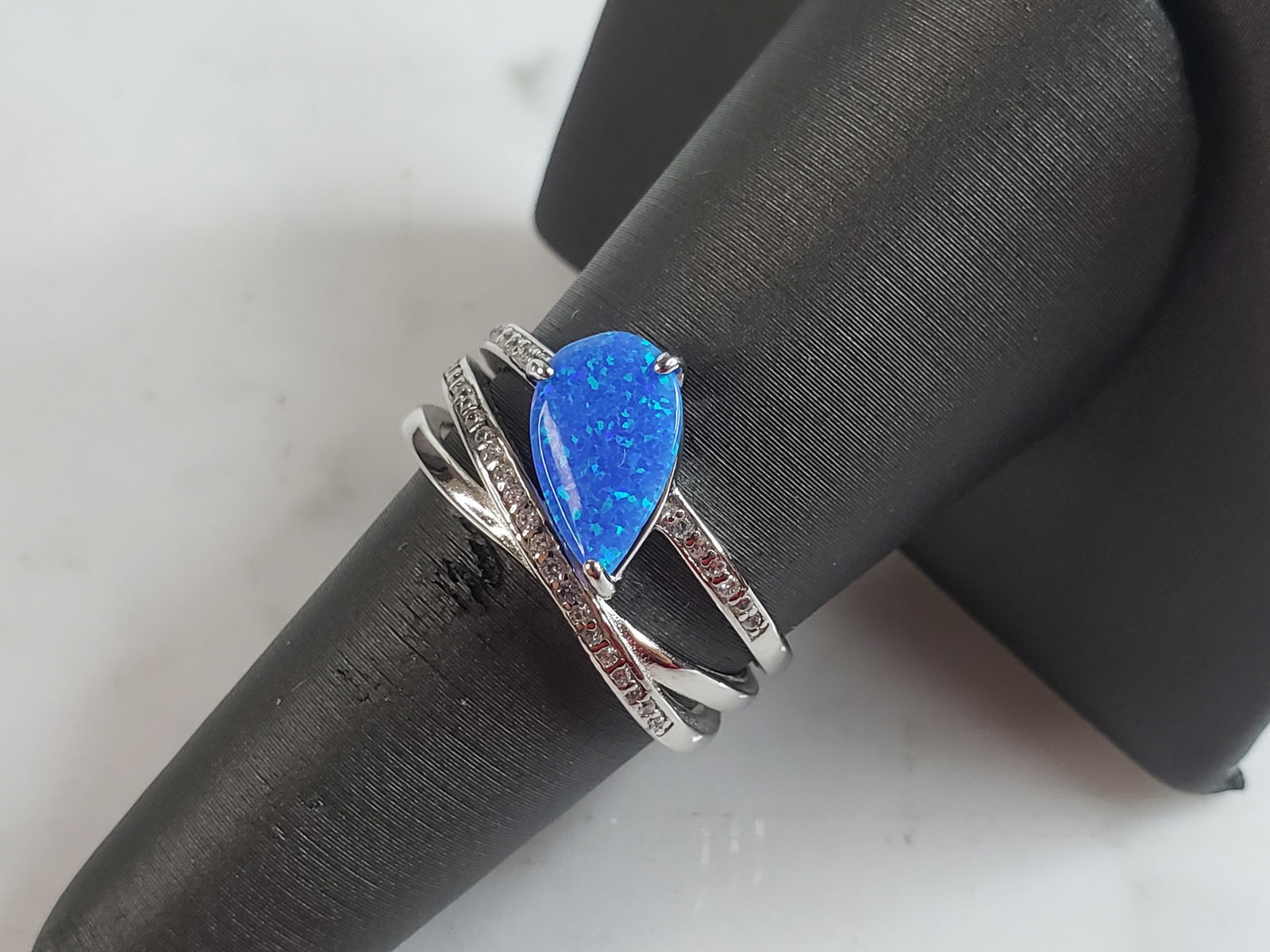 Womens Estate Sterling Silver Modernist Blue Opal Ring: A WOMENS ESTATE STERLING SILVER MODERNIST OPAL COLORED RING. THE RING IS A SIZE 7.25 AND WEIGHS 4.3g. WIDTH OF THE RING MEASURES 1/2". NOT SURE IF STONE IS NATURAL OR MAN MADE. THE RING MAKES A BEAUTI