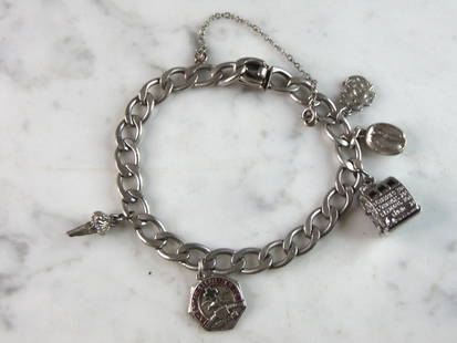 Women's Vintage Estate Sterling Silver Charm Bracelet: A WOMENS VINTAGE ESTATE STERLING SILVER CHARM BRACELET. BRACELET MEASURES 7 3/4" LONG BY 1/4" WIDE AND WEIGHS 30g. BRACELET HAS A FEW DIFFERENT CHARMS. ANY OTHER QUESTIONS PLEASE ASK. BE SURE TO CHECK