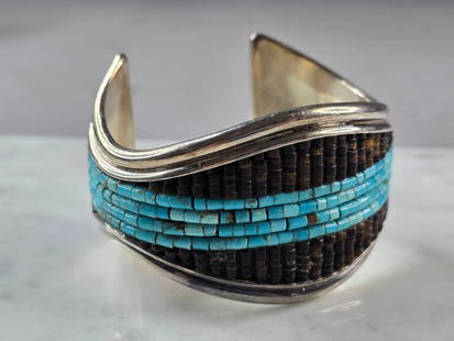 Vintage Estate Sterling Silver Turquoise Heishi Navajo Cuff Bracelet: A BEAUTIFUL VINTAGE ESTATE STERLING SILVER NAVAJO CUFF BRACELET THAT IS ARTIST SIGNED. THE BRACELET MEASURES 6 7/8" IN CIRCUMFERENCE, BY ABOUT 1 5/8" WIDE. BRACELET WEIGHS 82.6g. DOES HAVE A PARTIAL M
