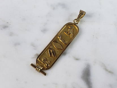 Vintage Estate 18K Yellow Gold Egyptian Hieroglyph Pendant: A VINTAGE ESTATE 18K YELLOW GOLD EGYPTIAN HIEROGLYPH PENDANT. THE PENDANT MEASURES 1 3/4" BY 3/8", AND WEIGHS 2.3g. PENDANT HAS A FAINT FOREIGN MARK ON THE BACK TOP CORNER. MAKES A GREAT GIFT FOR THAT