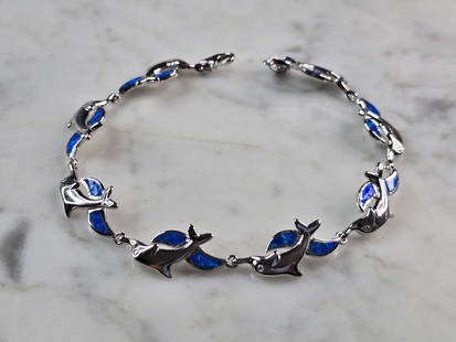Womens Sterling Silver Opal Dolphin Bracelet: A WOMENS STERLING SILVER MODERNIST OPAL COLORED DOLPHIN BRACELET. THE BRACELET WEIGHS 12.1g AND MEASURES 7 7/8" LONG BY 1/2" WIDE. NOT SURE IF OPAL IS NATURAL OR MAN MADE. ANY QUESTIONS PLEASE DO NOT