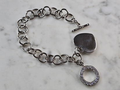 Womens Vintage Estate Sterling Silver Heart Charm Bracelet: A WOMENS VINTAGE ESTATE STERLING SILVER HEART CHARM CZ BRACELET. BRACELET MEASURES 8" LONG BY 3/8" WIDE AND WEIGHS 23.6g. THIS WOULD MAKE A LOVELY GIFT FOR THAT SOMEONE SPECIAL. ANY QUESTIONS, PLEASE