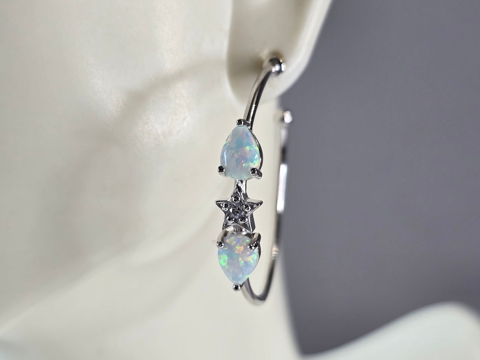 Womens Sterling Silver Modernist Opal Star Hoop Earrings: A PAIR OF WOMENS STERLING SILVER OPAL COLORED EARRINGS THAT WEIGH 4.7g AND MEASURES 1 1/4" LONG BY 3/16" WIDE. NOT SURE IF STONES ARE NATURAL OR MAN MADE. ANY QUESTIONS, PLEASE DO NOT HESITATE TO ASK.