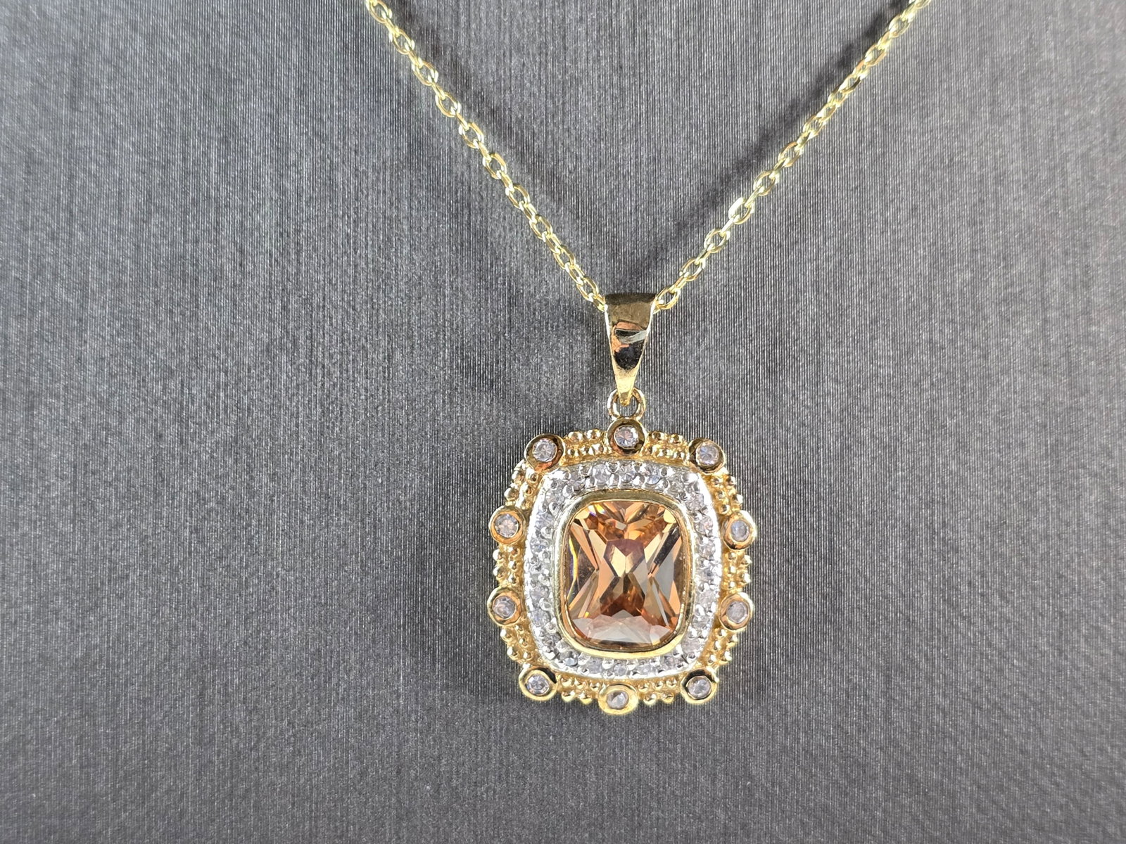 Womens Sterling Silver Gold Tone Citrine Pendant Necklace: A WOMENS GOLD TONE STERLING SILVER CITRINE PENDANT WITH NECKLACE. THE TOTAL WEIGHT IS 7.6g. PENDANT MEASURES 1 1/4" LONG BY 1" WIDE, AND NECKLACE IS 18" LONG. NOT SURE IF THE STONES ARE NATURAL OR MAN