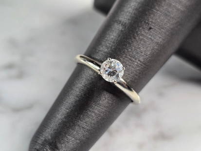 Womens Vintage Estate 14K White Gold Diamond Engagement Ring: A WOMENS VINTAGE ESTATE 14K WHITE GOLD DIAMOND ENGAGEMENT RING. THE RING IS A SIZE 5.25 AND WEIGHS 2.4g. DIAMOND IS ABOUT .25cts. THE WIDTH OF THE RING IS 3/16". RING IS MARKED ON THE INSIDE OF THE BA