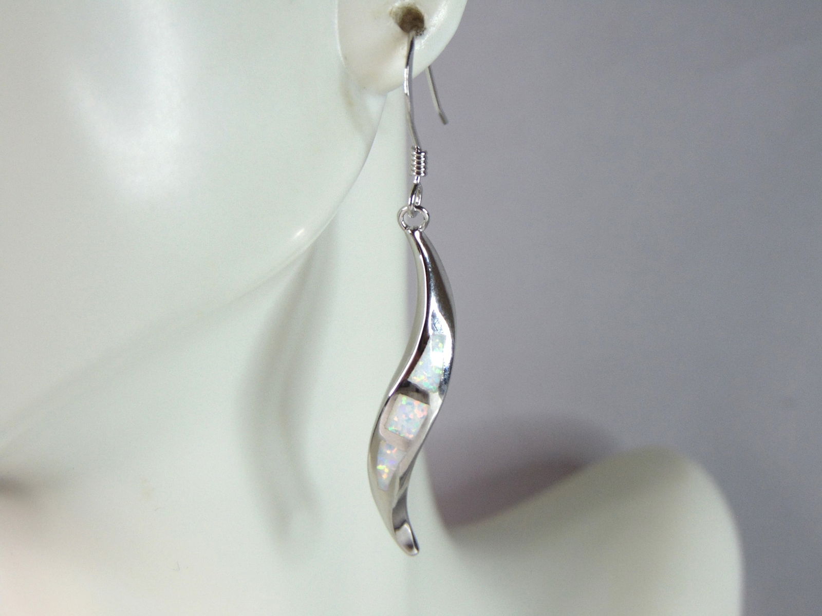 Womens Estate Sterling Silver Modernist Opal Earrings: WOMENS ESTATE STERLING SILVER MODERNIST OPAL COLORED EARRINGS THAT WEIGH 4.2g. EARRINGS MEASURE 1 3/4" LONG BY 1/4" WIDE. NOT SURE IF STONES ARE REAL OR MAN MADE. ANY QUESTIONS, PLEASE DO NOT HESITATE