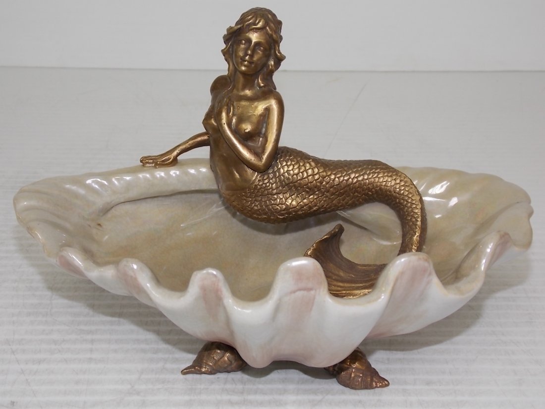 PORCELAIN CANDY DISH W/ BRONZE MERMAID & SEASHELL: A PORCELAIN CANDY DISH WITH A BRONZE MERMAID AND BRONZE SEASHELL FEET. PIECE MEASURES 7 1/4" TALL BY 10 1/2" LONG BY 7" WIDE. SHIPPING AND HANDLING IS $30 WITHIN THE CONTINENTAL US. ALL OTHER STATES A