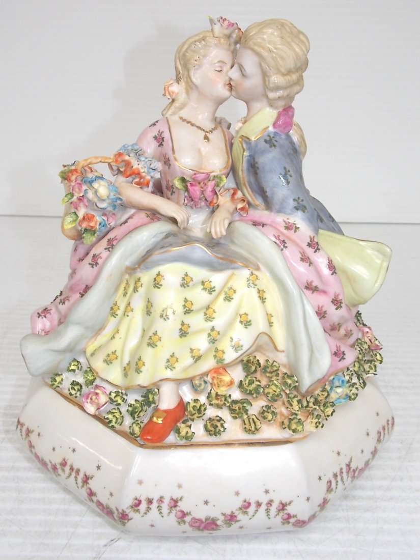 VICTORIAN HAND PAINTED PORCELAIN OCTAGON BOX: HAND PAINTED PORCELAIN OCTAGON BOX WITH COUPLE KISSING IS ADORNED WITH A MULTITUDE OF HAND FORMED AND PAINTED PORCELAIN FLOWERS AND GOLD TRIM. THE BOX STANDS 11 1/2 INCHES TALL AND MEASURES 10 1/2 INC