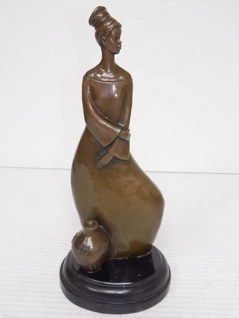BRONZE CONTEMPORARY TRIBAL WOMAN WITH BASKET: BRONZE “CONTEMPORARY TRIBAL WOMAN WITH BASKET” STANDS 15 3/4” TALL MOUNTED ON ITS SLIGHTLY OVAL MARBLE BASE. SHIPPING IS $35 WITHIN THE CONTINENTAL US. ALL OTHER STATES AND COUNTRIES PLEASE CONT