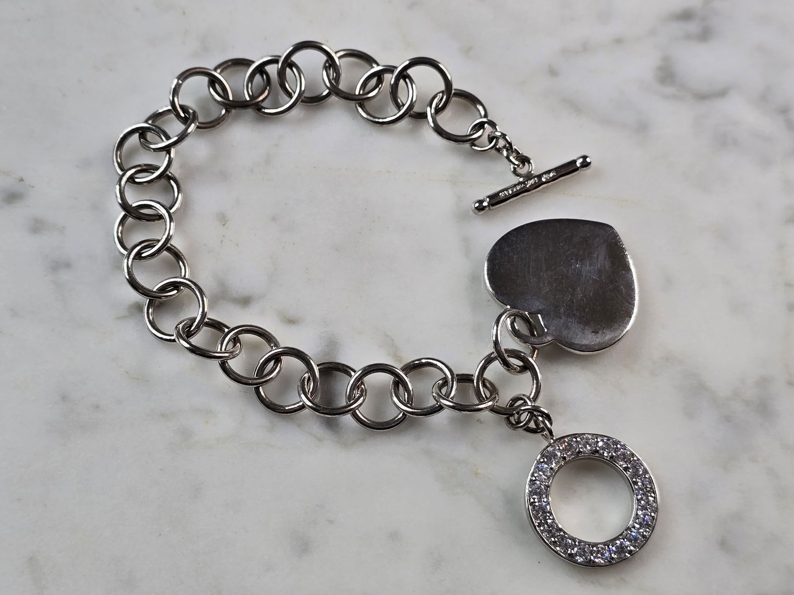 Womens Vintage Estate Sterling Silver Heart Charm Bracelet: A WOMENS VINTAGE ESTATE STERLING SILVER HEART CHARM CZ BRACELET. BRACELET MEASURES 8" LONG BY 3/8" WIDE AND WEIGHS 23.6g. THIS WOULD MAKE A LOVELY GIFT FOR THAT SOMEONE SPECIAL. ANY QUESTIONS, PLEASE