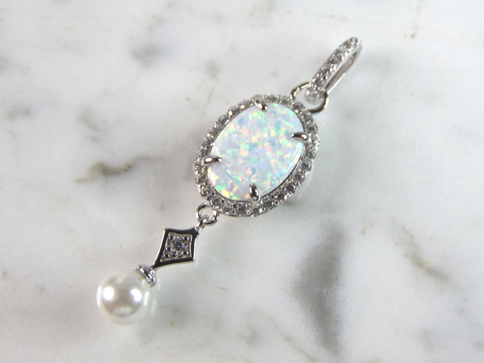 Womens Estate Sterling Silver Modernist Opal Pendant: WOMENS ESTATE STERLING SILVER MODERNIST OPAL COLORED PENDANT WEIGHES 3.9g AND MEASURES 1 1/2" LONG BY 1/2" WIDE. NOT SURE IF STONES ARE REAL OR MAN MADE. ANY OTHER QUESTIONS, PLEASE DO NOT HESITATE TO