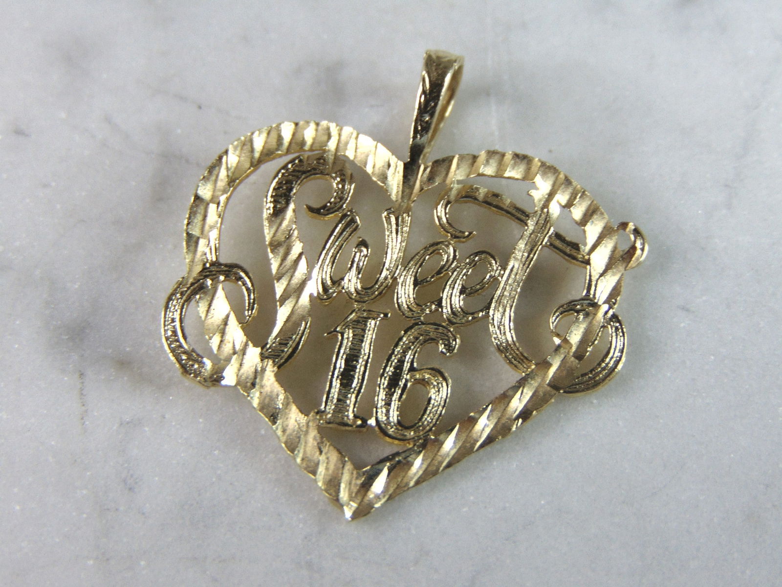 Womens Vintage Estate 14K Yellow Gold Sweet 16 Heart Pendant: A WOMEN'S VINTAGE ESTATE 14K YELLOW GOLD SWEEET 16 HEART PENDANT. PENDANT MEASURES 1" LONG BY 1" WIDE. TOTAL WEIGHT OF THE PENDANT IS 1.7g. WOULD MAKE A LOVELY GIFT FOR THAT SOMEONE SPECIAL. ANY QUEST