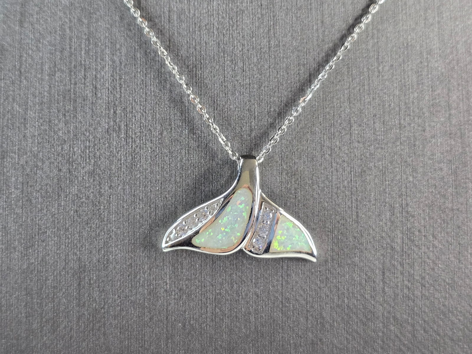 Womens Sterling Silver Opal Modernist Whale Tail Pendant Necklace: A WOMENS STERLING SILVER OPAL MODERNIST WHALE TAIL PENDANT. THE PENDANT WITH NECKLACE WEIGHS 5.0g. PENDANT MEASURES 1" LONG BY 1/2" WIDE, AND THE NECKLACE MEASURES 18" LONG, ADJUSTABLE TO 16". NOT SUR