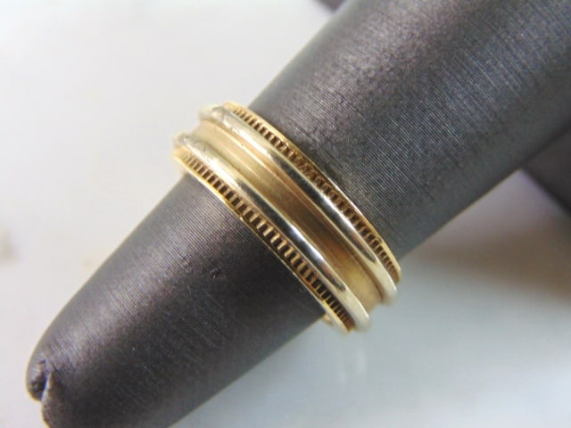 Womens Vintage Estate 14K Yellow Gold Band Wedding Ring: A WOMENS 14K GOLD WEDDING BAND. THE RING WEIGHS 8.2g. THE SIZE OF THE RING IS A 5.0, AND MEASURES 1/4" WIDE. RING IS MARKED "14K" ON THE INSIDE OF THE BAND. ALSO HAS A FAINT MAKERS MARK THAT I CANT MA