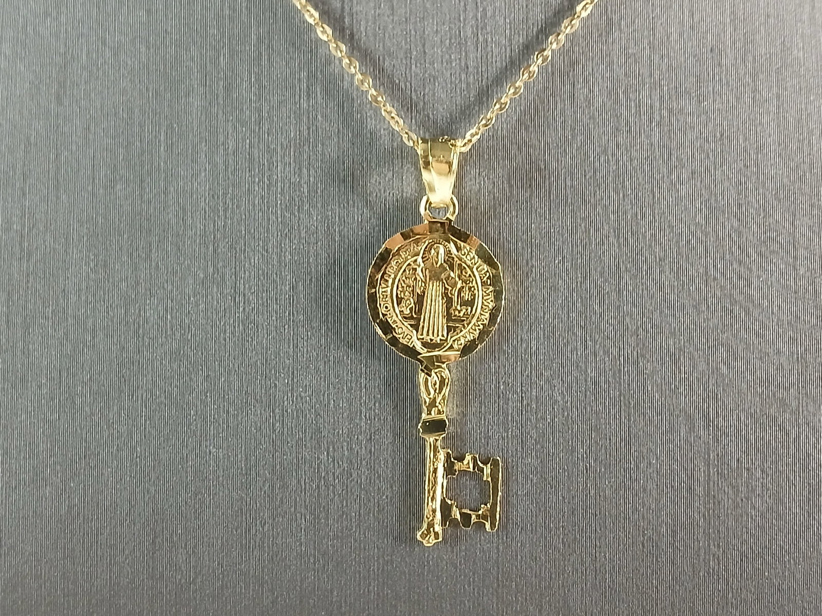 Womens Sterling Silver Gold Tone Saint Benedict Key Pendant Necklace: A WOMENS STERLING SILVER GOLD TONE RELGIOUS SAINT BENEDICT KEY PENDANT WITH NECKLACE . THE TOTAL WEIGHT IS 3.1g. THE PENDANT MEASURES 1 1/2" LONG BY 1/2" WIDE, AND THE NECKLACE MEASURES 18" LONG, AND