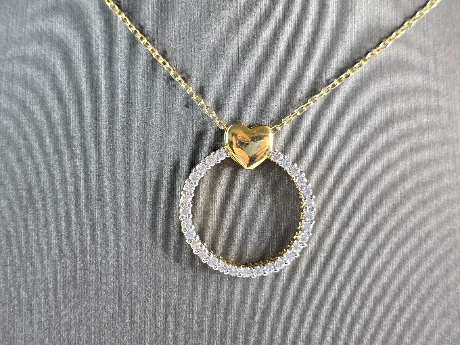 Womens Sterling Silver Gold Tone CZ Heart Eternity Pendant Necklace: A WOMENS STERLING SILVER GOLD TONE CZ ETERNITY HEART PENDANT WITH NECKLACE. THE PENDANT MEASURES 1" BY 3/4" WIDE. NECKLACE MEASURES 18" LONG. TOGETHER THEY WEIGH 4.3g. WOULD MAKE A GREAT GIFT FOR THAT
