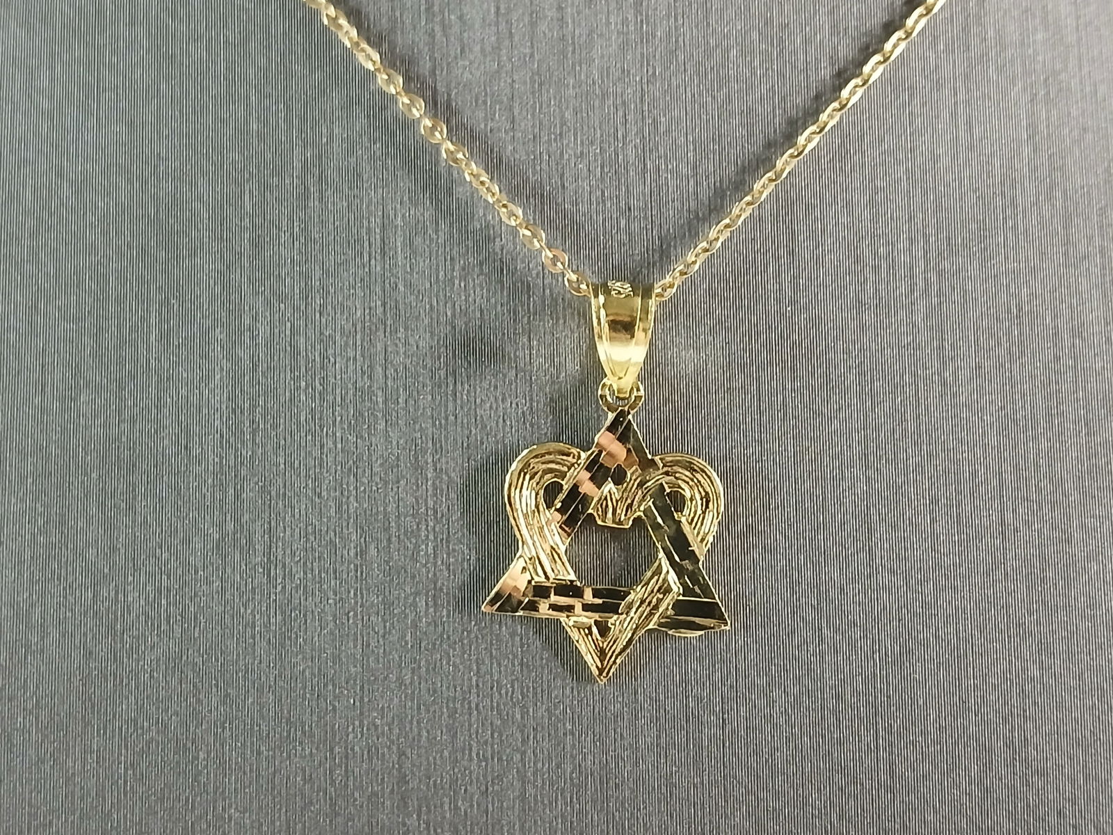 Sterling Silver GT Jewish Judaica Star David Heart Pendant Necklace: A STERLING SILVER GOLD TONE MODERNIST STAR OF DAVID HEART PENDANT. THE PENDANT WITH NECKLACE WEIGHS 2.4g. PENDANT MEASURES 7/8" LONG BY 1/2" WIDE. THE NECKLACE MEASURES 18" LONG AND IS ADJUSTABLE TO 1