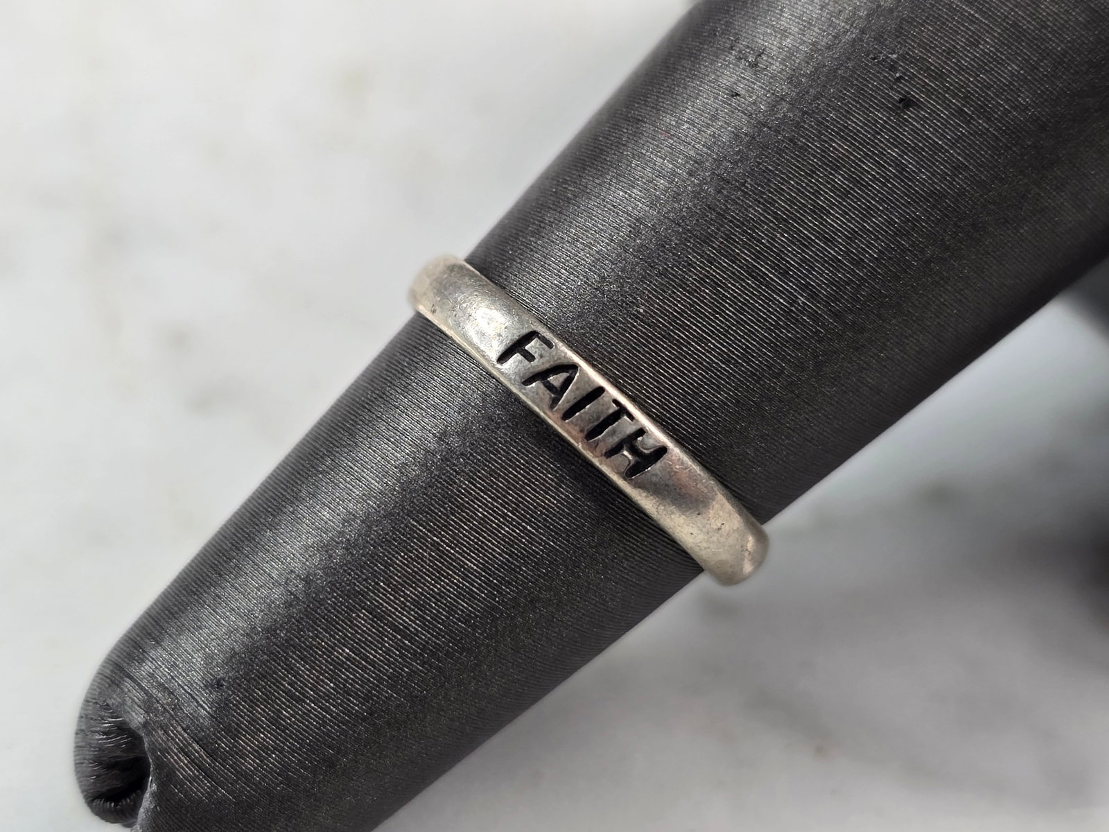 Womens Vintage Estate Sterling Silver Faith Ring: A WOMENS VINTAGE ESTATE STERLING SILVER "FAITH" RING. THE RING SIZE IS A 5.0, AND WEIGHS 1.2g. THE WIDTH OF THE RING IS 1/8". THIS WOULD MAKE A NICE GIFT FOR THAT SOMEONE SPECIAL. ANY OTHER QUESTIONS