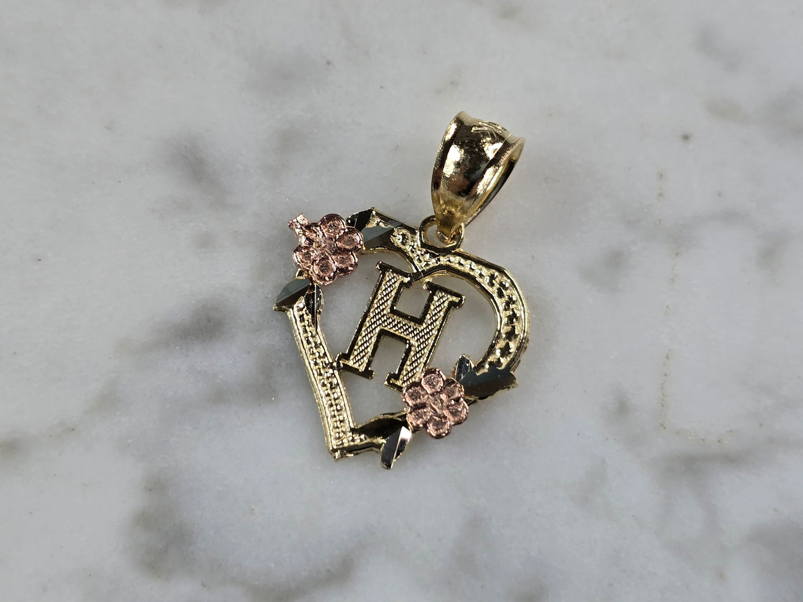 Womens 10K Yellow & Rose Gold Initial Letter " H " Heart Pendant: A WOMENS 10K YELLOW & ROSE GOLD "H" HEART PENDANT. PENDANT MEASURES 3/4" LONG BY 5/8" WIDE. TOTAL WEIGHT OF THE PENDANT IS 0.9g. WOULD MAKE A LOVELY GIFT FOR THAT SOMEONE SPECIAL. ANY QUESTIONS PLEASE