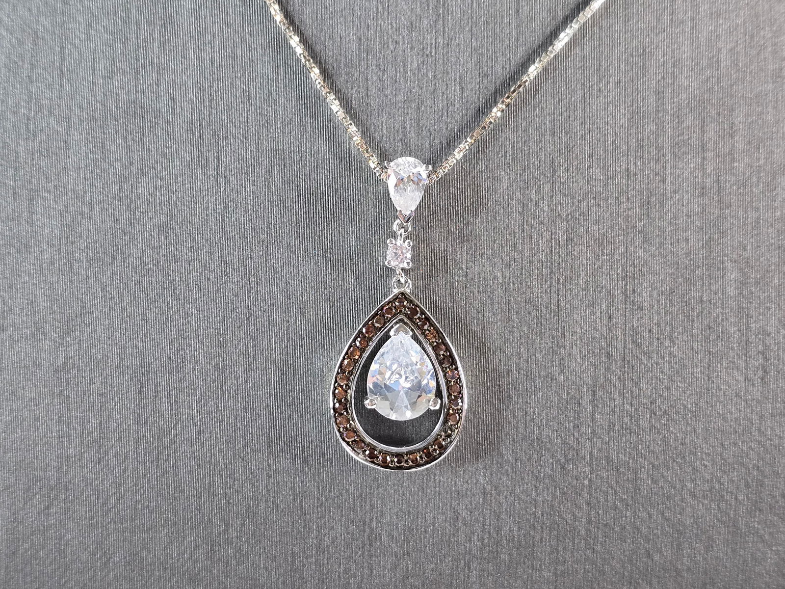 Womens Estate Sterling Silver Modernist Citrine CZ Pendant Necklace: A WOMENS VINTAGE ESTATE STERLING SILVER NECKLACE WITH A CITRINE & CZ PENDANT. THE PENDANT MEASURES 1 1/4" BY 7/8". THE NECKLACE MEASURES 18" LONG. TOGETHER THEY WEIGH 5.5g. NOT SURE IF THE STONE IS NA