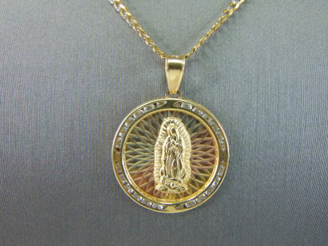 14K Mixed Gold Necklace W/ Religious Pendant: A 14K MIXED GOLD NECKLACE AND RELIGIOUS PENDANT. THE TOTAL WEIGHT IS 7.3g. THE NECKLACE MEASURES ABOUT 18" LONG BY 1/8" WIDE. THE PENDANT MEASURES 1 1/4" LONG BY 1" WIDE. STONES ARE CZ AND BOTH ARE MA