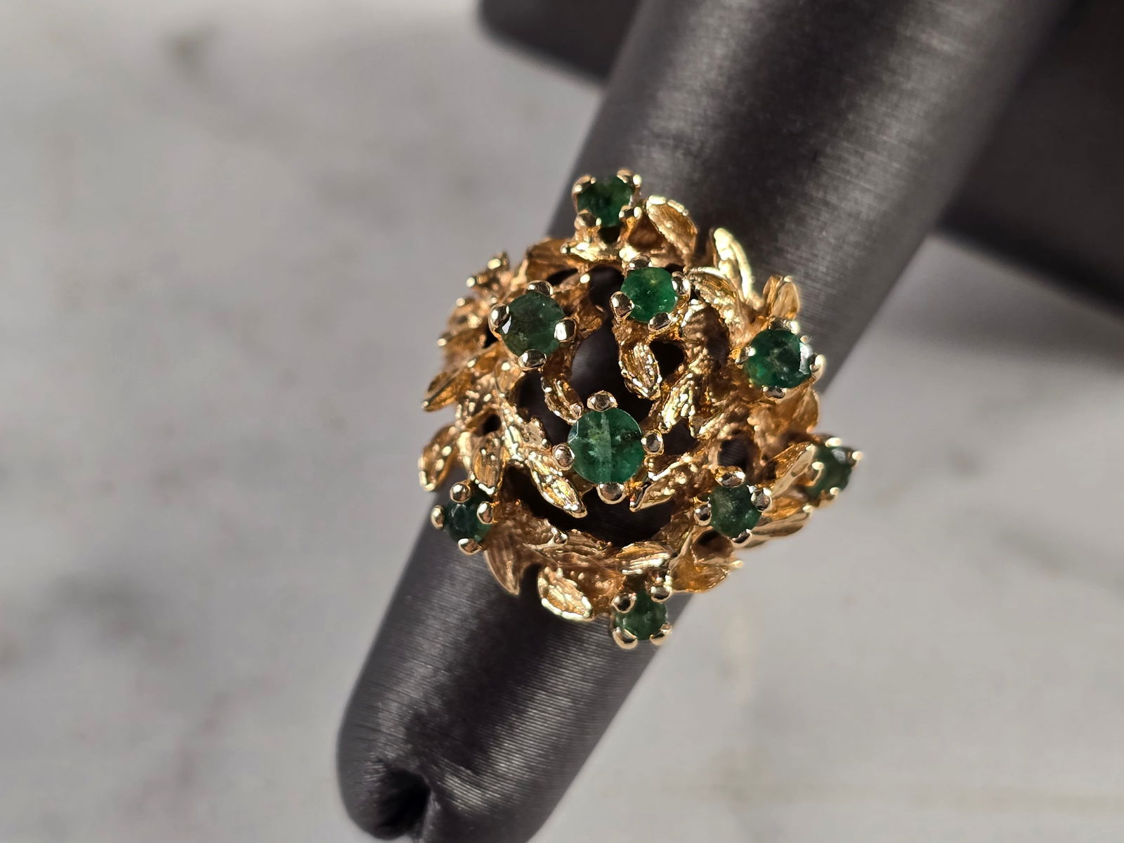 Womens Vintage Estate 14k Yellow Gold Modernist Emerald Ring: A UNIQUE WOMENS VINTAGE ESTATE 14K YELLOW GOLD MODERNIST RING WITH EMERALD STONES. THE RING SIZE IS A 5.25 AND WEIGHS 8.9g. THE LENGTH OF THE RING IS 7/8". THIS WOULD MAKE A NICE GIFT FOR THAT SOMEONE
