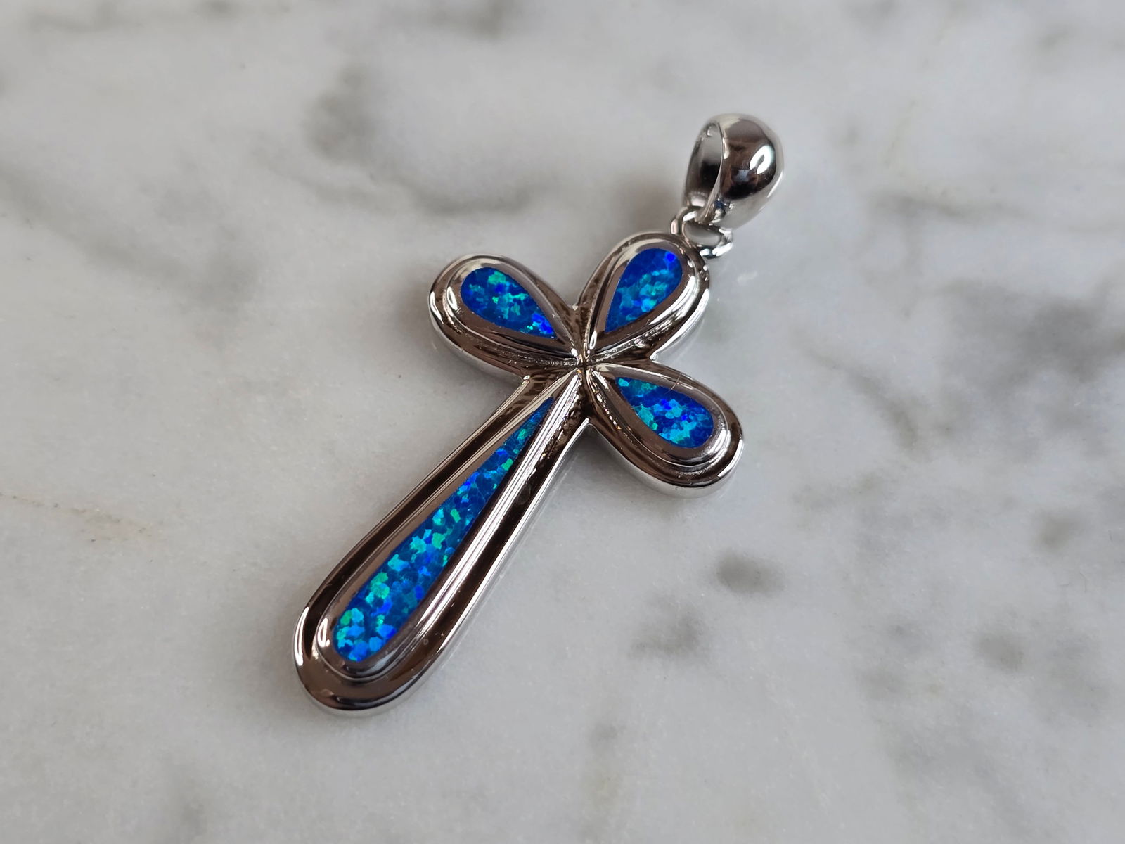 Womens Sterling Silver Blue Opal Religious Cross Pendant: A WOMENS ESTATE STERLING SILVER BLUE OPAL RELIGIOUS CROSS PENDANT. NOT SURE IF STONES ARE REAL OR MAN MADE. THE PENDANT WEIGHS 4.1g, AND MEASURES 1 3/8" LONG BY 5/8" WIDE. MAKES A GREAT GIFT FOR