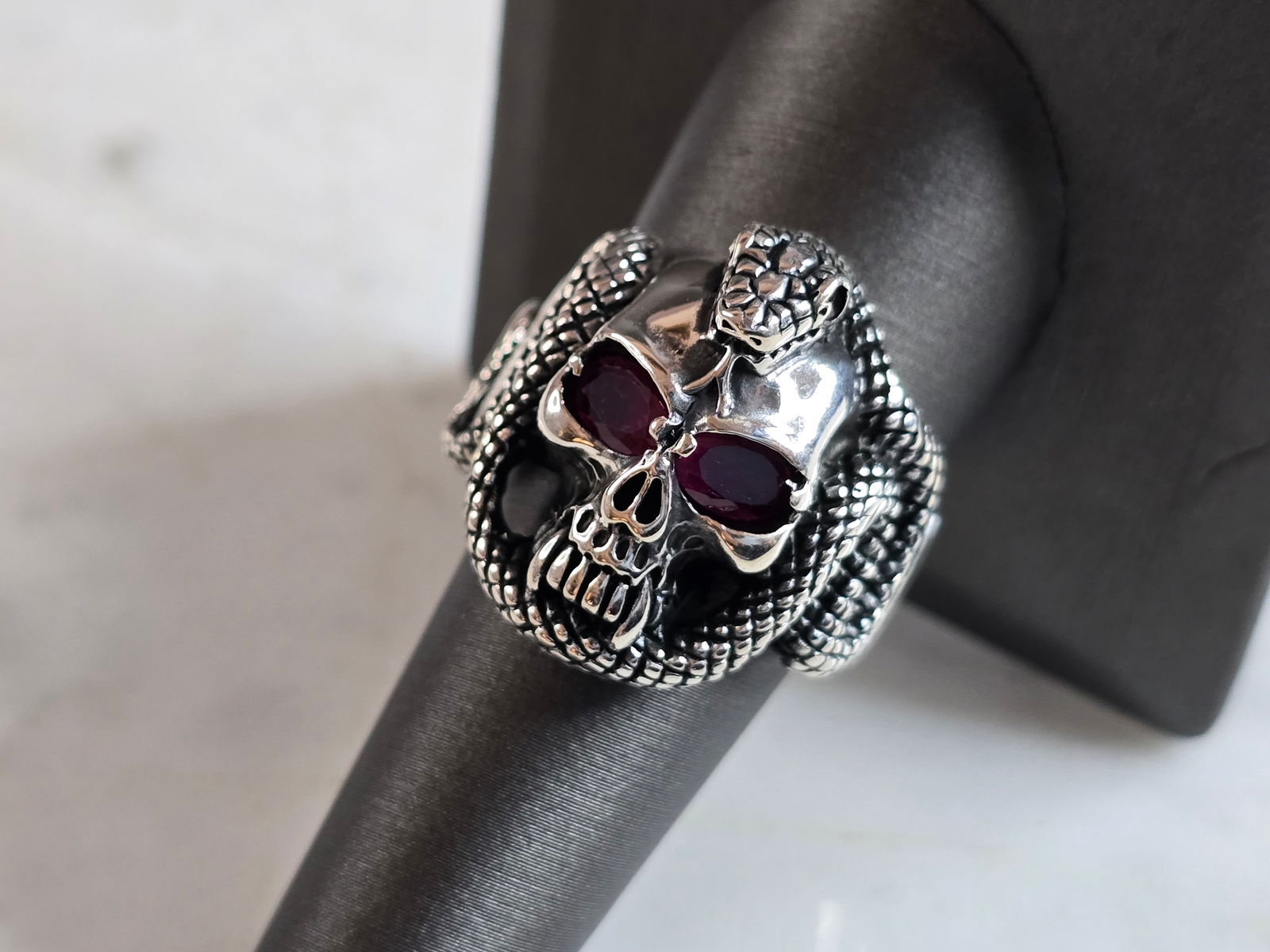 Mens Sterling Silver Ruby Eyed Goth Biker Skull Snake Ring: A MENS STERLING SILVER RUBY EYED SKULL SNAKE RING. THE TOTAL WEIGHT IS 14.3g, AND IS A SIZE 9.75. THE LENGTH OF THE RING FACE IS 7/8". STONES TESTED RUBY ON OUR PRESIDIUM GEM TESTER, HOWEVER NOT SURE