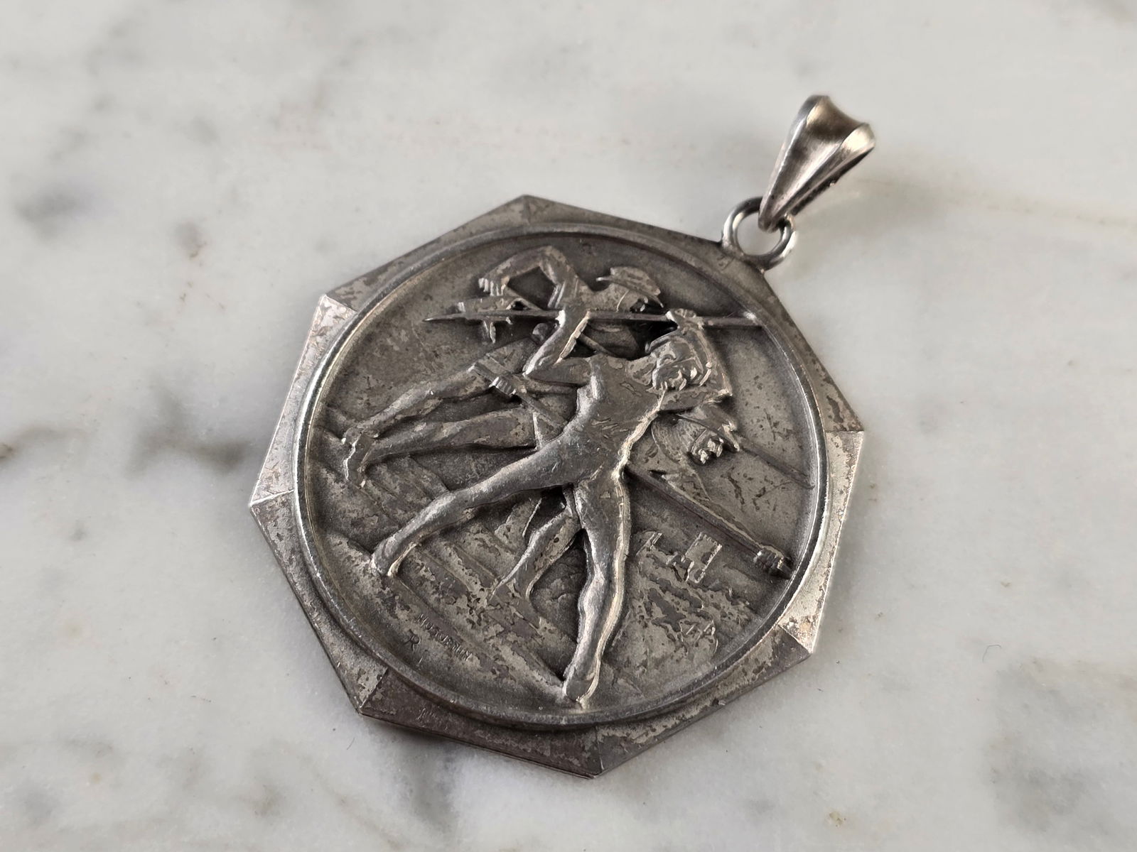 Rare Sterling Silver 1956 Swiss German Huguenin Rifle Medal Pendant: A RARE SWISS OR GERMAN STERLING SILVER MEDAL PENDANT THAT WAS MADE BY HUGUENIN, 1956. MEDAL WEIGHS 14.7g, AND MEASURES 1 3/4" BY 1 1/4". I BELIEVE THE BACK TRANSLATES TO " WE PROTECT OUR WOMEN", "CANT