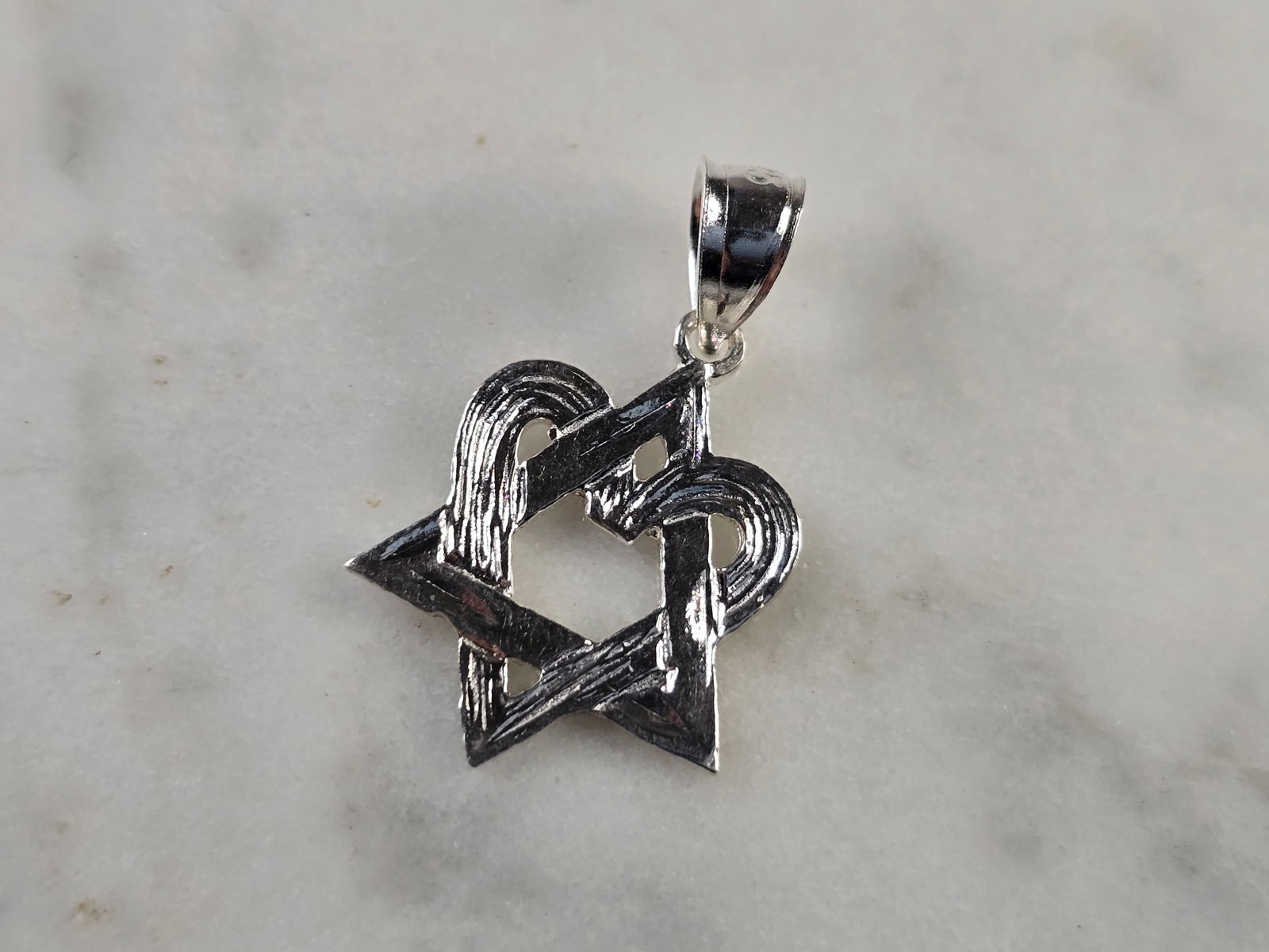 Sterling Silver Jewish Judaica Star of David Heart Pendant: A STERLING SILVER MODERNIST STAR OF DAVID HEART PENDANT. THE PENDANT WEIGHS 1.0g, AND MEASURES 7/8" LONG BY 1/2" WIDE. MAKES A GREAT GIFT FOR THAT SOMEONE SPECIAL. ANY QUESTIONS, PLEASE ASK. BE SURE T