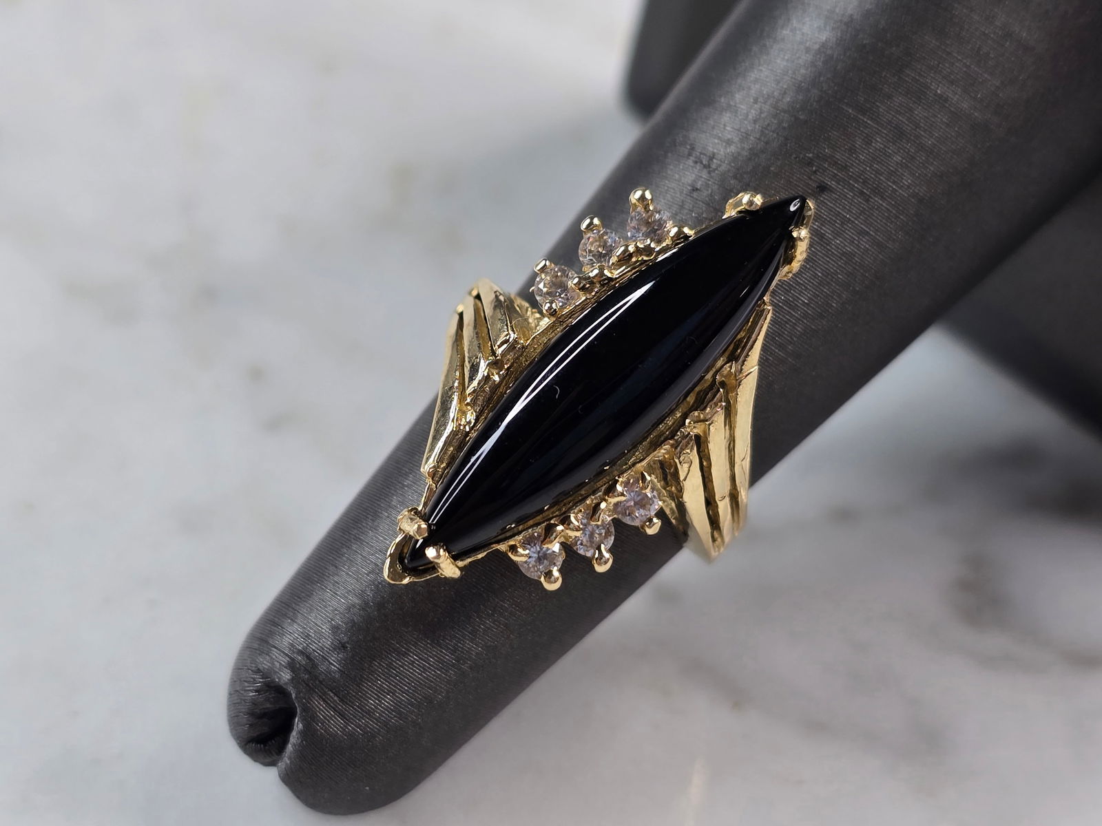 Womens Vintage Estate 14K Yellow Gold Onyx CZ Ring: A WOMEN'S VINTAGE ESTATE 14K GOLD ONYX COLORED STONE & CZ RING. THE RING WEIGHS 4.8g, AND IS A SIZE 5.0. THE LENGTH OF THE RING IS 1". STONE IS MAN MADE. THIS IS A LOVELY GIFT FOR THAT SPECIAL SOMEONE