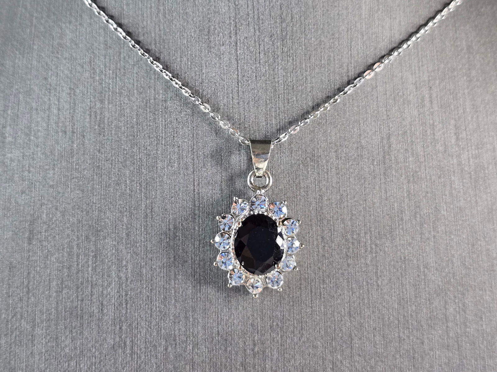Womens Estate Sterling Silver Sapphire CZ Pendant Necklace: A WOMENS VINTAGE ESTATE STERLING SILVER SAPPHIRE CZ PENDANT WITH NECKLACE. PENDANT AND NECKLACE WEIGHS 4.0g. PENDANT MEASURES 1" LONG BY 1/2" WIDE. THE NECKLACE MEASURES 18" LONG, AND IS ADJUSTABLE TO