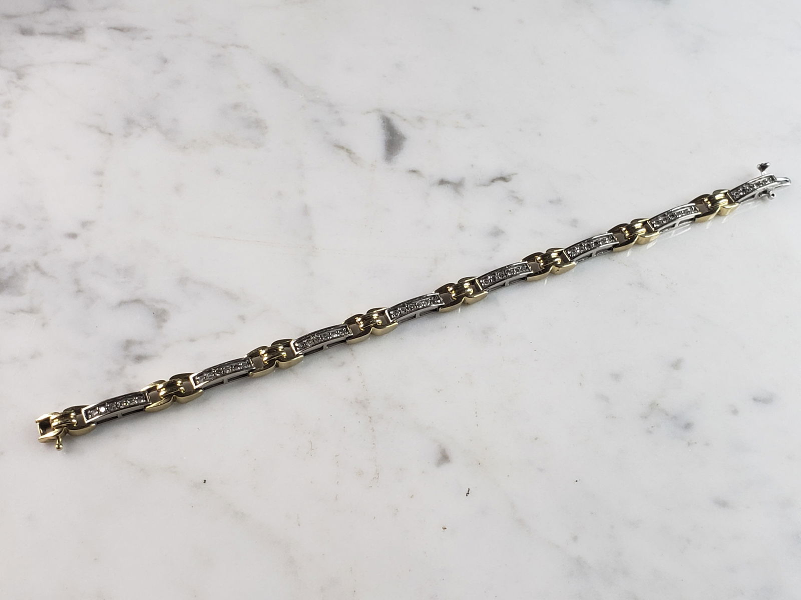 Womens Vintage Estate 10K Yellow & White Gold Diamond Tennis Bracelet: A WOMENS VINTAGE ESTATE 10K YELLOW & WHITE GOLD TENNIS BRACELET WITH ABOUT 2.0cts OF DIAMONDS. THE BRACELET MEASURES 7 1/4" LONG BY 1/4" WIDE, AND WEIGHS 14.9g. BRACELET IS NOT MARKED BUT IT HAS BEEN