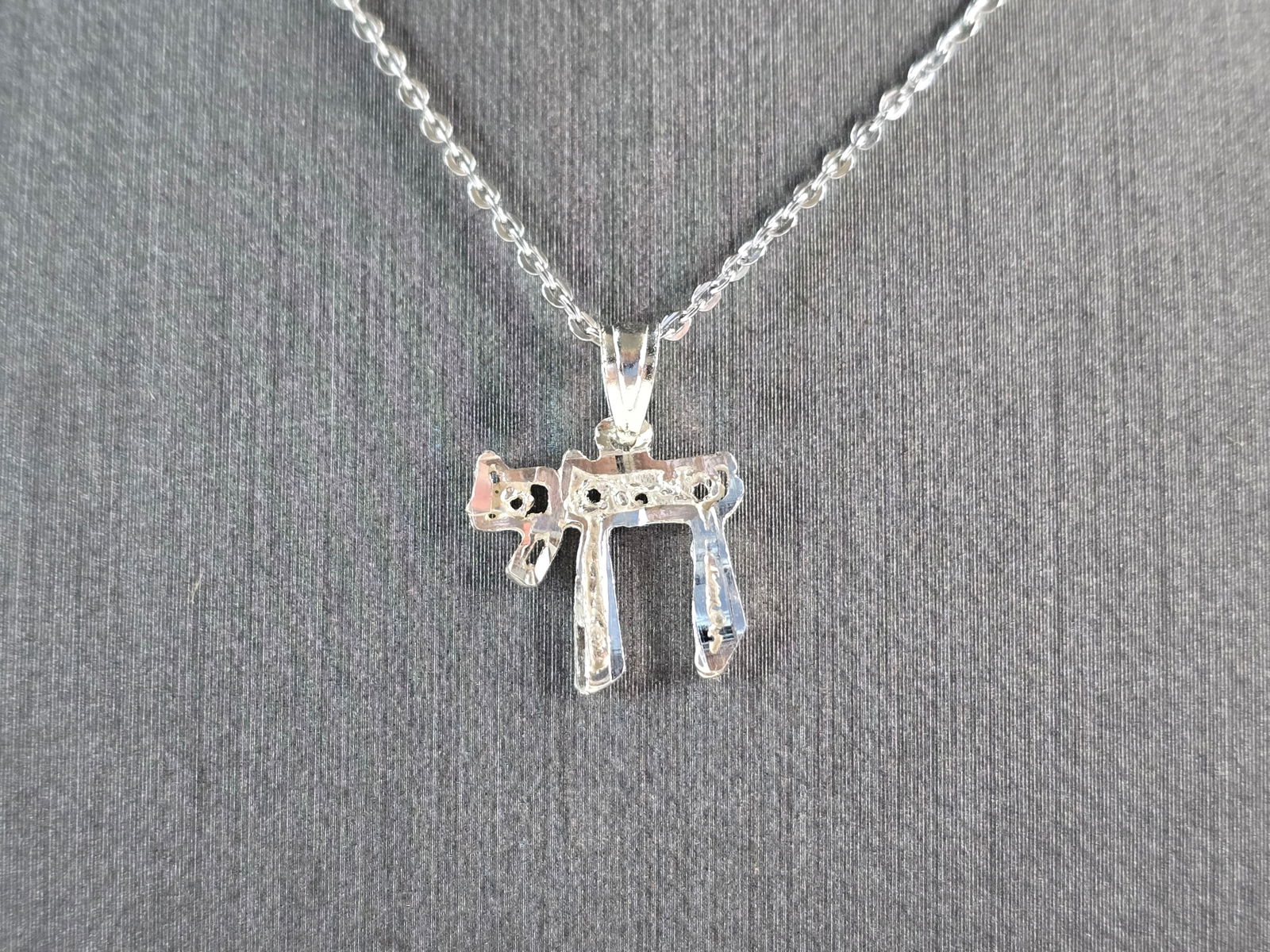 Womens Sterling Silver Jewish Hebrew Religious Chai Pendant Necklace: A STERLING SILVER JEWISH HEBREW CHAI OR LIFE PENDANT WITH NECKLACE. PENDANT WITH NECKLACE WEIGHS 2.1g. THE PENDANT MEASURES 1/2" LONG BY 1/2" WIDE, AND THE NECKLACE MEASURES 18" LONG AND IS ADJUSTABLE