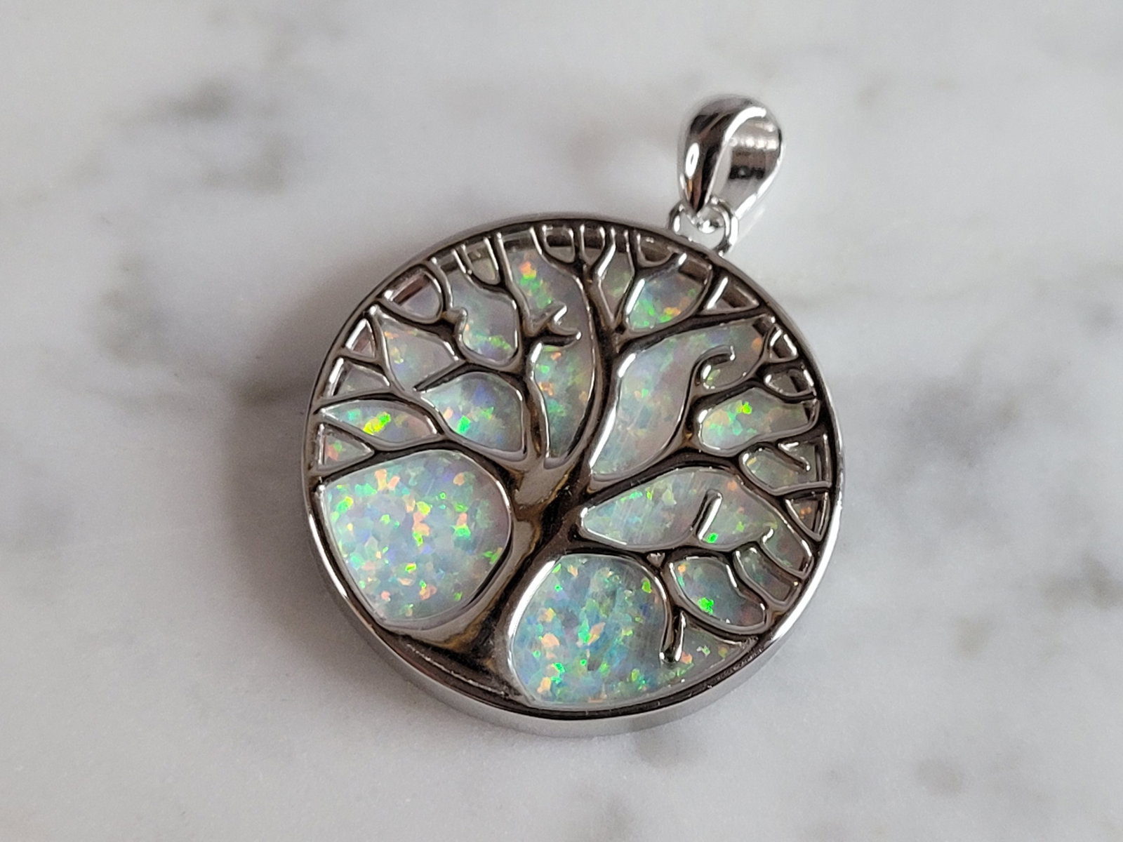 Womens Sterling Silver Opal Tree of Life Pendant: A WOMENS ESTATE STERLING SILVER OPAL TREE OF LIFE PENDANT. NOT SURE IF STONES ARE REAL OR MAN MADE. THE PENDANT WEIGHS 6.2g AND MEASURES 1 1/8" LONG BY 1" WIDE. MAKES A GREAT GIFT FOR THAT SOMEONE SPE