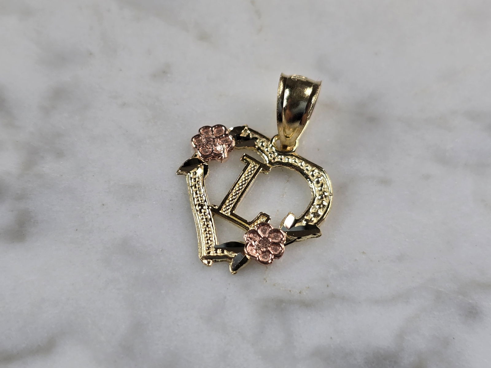 Womens 10K Yellow & Rose Gold Initial Letter " L " Heart Pendant: A WOMENS 10K YELLOW & ROSE GOLD "L" HEART PENDANT. PENDANT MEASURES 3/4" LONG BY 5/8" WIDE. TOTAL WEIGHT OF THE PENDANT IS 0.9g. WOULD MAKE A LOVELY GIFT FOR THAT SOMEONE SPECIAL. ANY QUESTIONS PLEASE