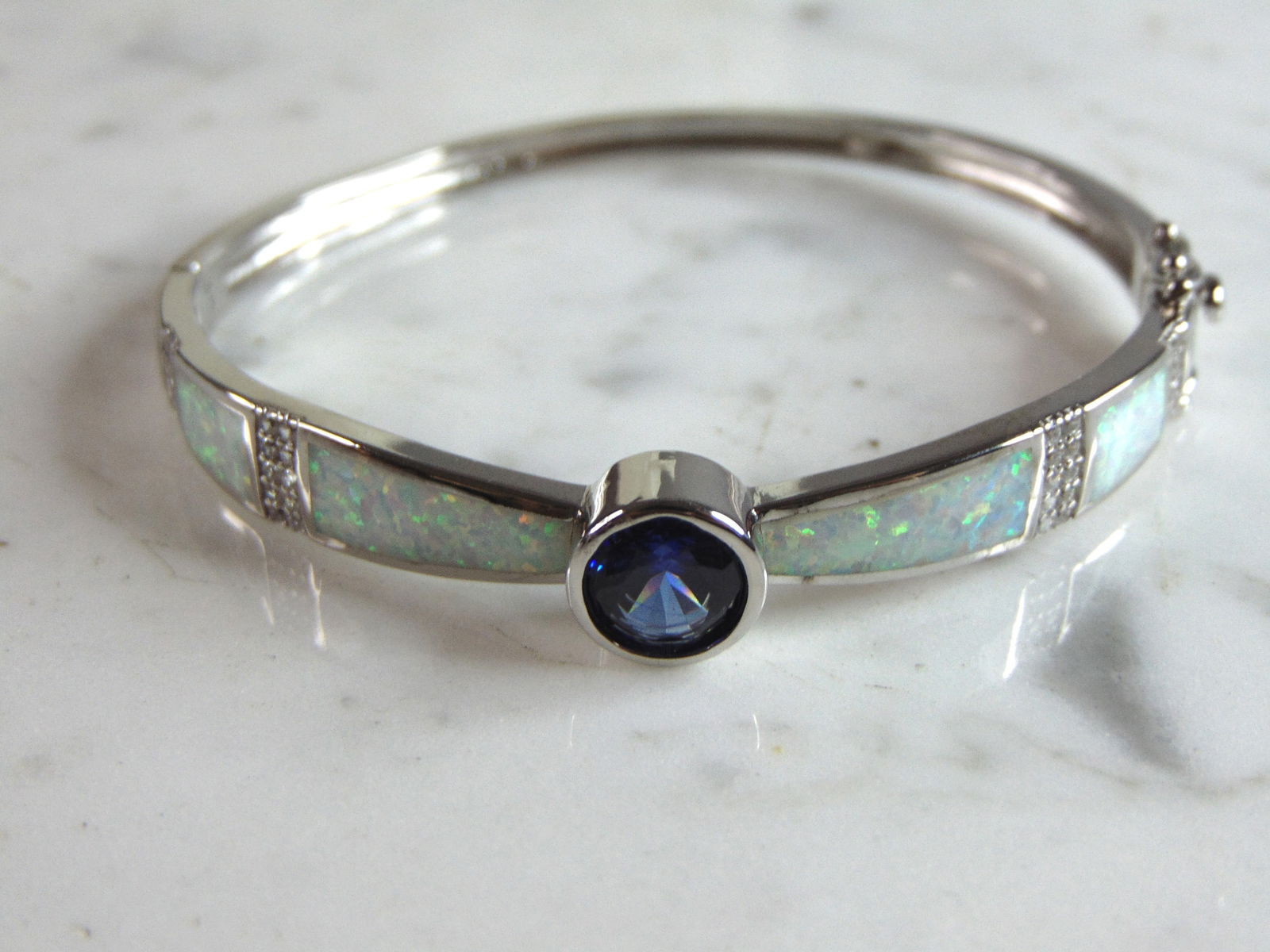 Womens Sterling Silver Modernist Opal Bangle Bracelet: FOR SALE IS THIS WONDERFUL WOMENS STERLING SILVER MODERNIST OPAL BANGLE BRACELET. THE BRACELET WEIGHS 15.2g AND IS ABOUT 1/4" WIDE. THE CIRCUMFERENCE WITH THE GAP IS 6 1/2". ANY QUESTIONS PLEASE DO NO