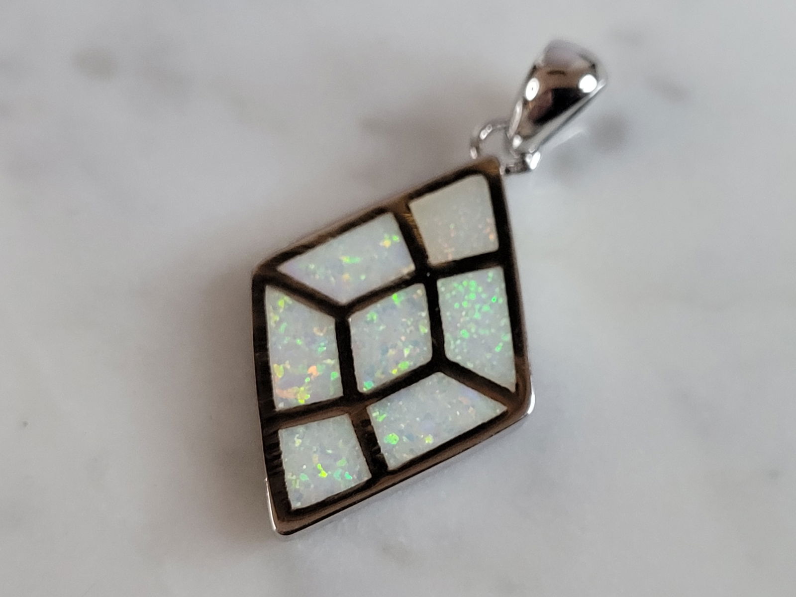 Womens Estate Sterling Silver Modernist Opal Pendant: WOMENS ESTATE STERLING SILVER MODERNIST OPAL COLORED PENDANT WEIGHES 3.2g, AND MEASURES 1 1/8" LONG BY 5/8" WIDE. NOT SURE IF STONES ARE REAL OR MAN MADE. ANY QUESTIONS, PLEASE DO NOT HESITATE TO ASK.