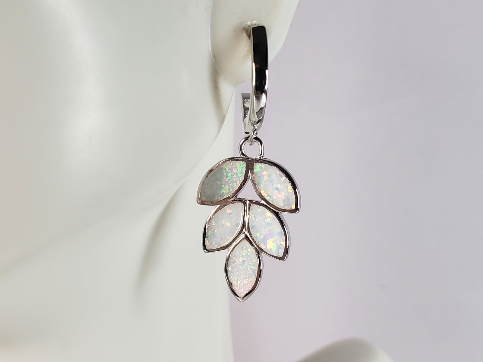 Womens Estate Sterling Silver Opal Leaf Earrings: A PAIR OF WOMENS STERLING SILVER OPAL COLORED LEAF EARRINGS THAT WEIGH 4.3g AND MEASURES 1 3/8" LONG BY 1/2" WIDE. NOT SURE IF STONES ARE REAL OR MAN MADE. ANY OTHER QUESTIONS, PLEASE DO NOT HESITATE