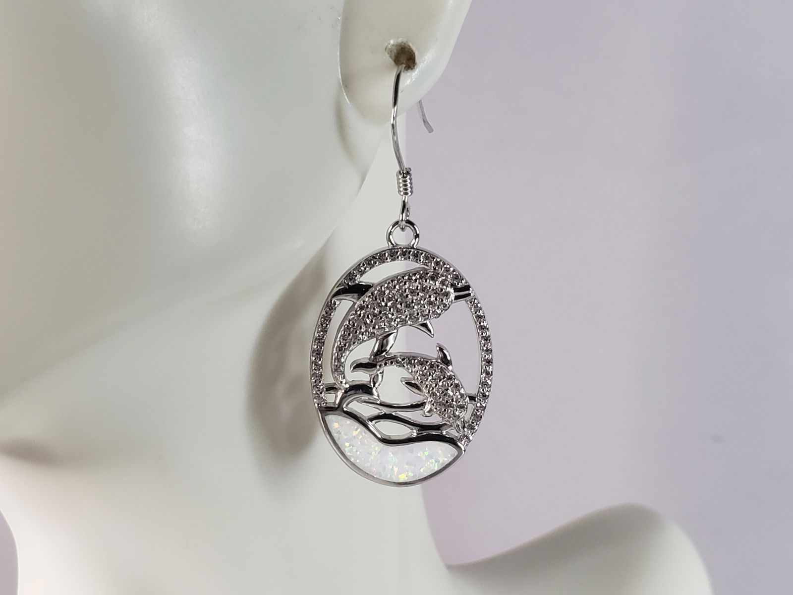 Womens Estate Sterling Silver Opal Dolphin Earrings: A PAIR OF WOMENS STERLING SILVER OPAL COLORED DOLPHIN EARRINGS THAT WEIGH 7.7g AND MEASURES 1 1/2" LONG BY 3/4" WIDE. NOT SURE IF STONES ARE REAL OR MAN MADE. ANY OTHER QUESTIONS, PLEASE DO NOT HESITA