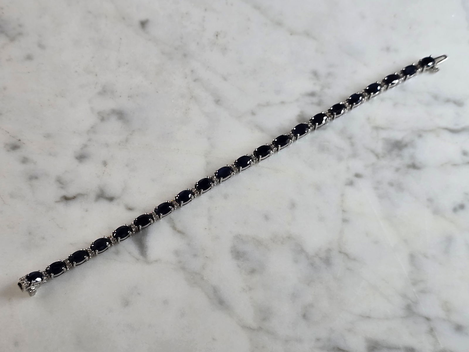 Womens Vintage Estate 14K White Gold Diamond & Sapphire Bracelet: A LOVELY WOMENS VINTAGE ESTATE 14K WHITE GOLD BRACELET WITH DIAMONDS AND SAPPHIRES. THE BRACELET MEASURES 7" LONG BY ABOUT 3/16" WIDE, AND WEIGHS 12.7g. THERE ARE 42 TINY DIAMONDS ACCENTING THE SAPPHI