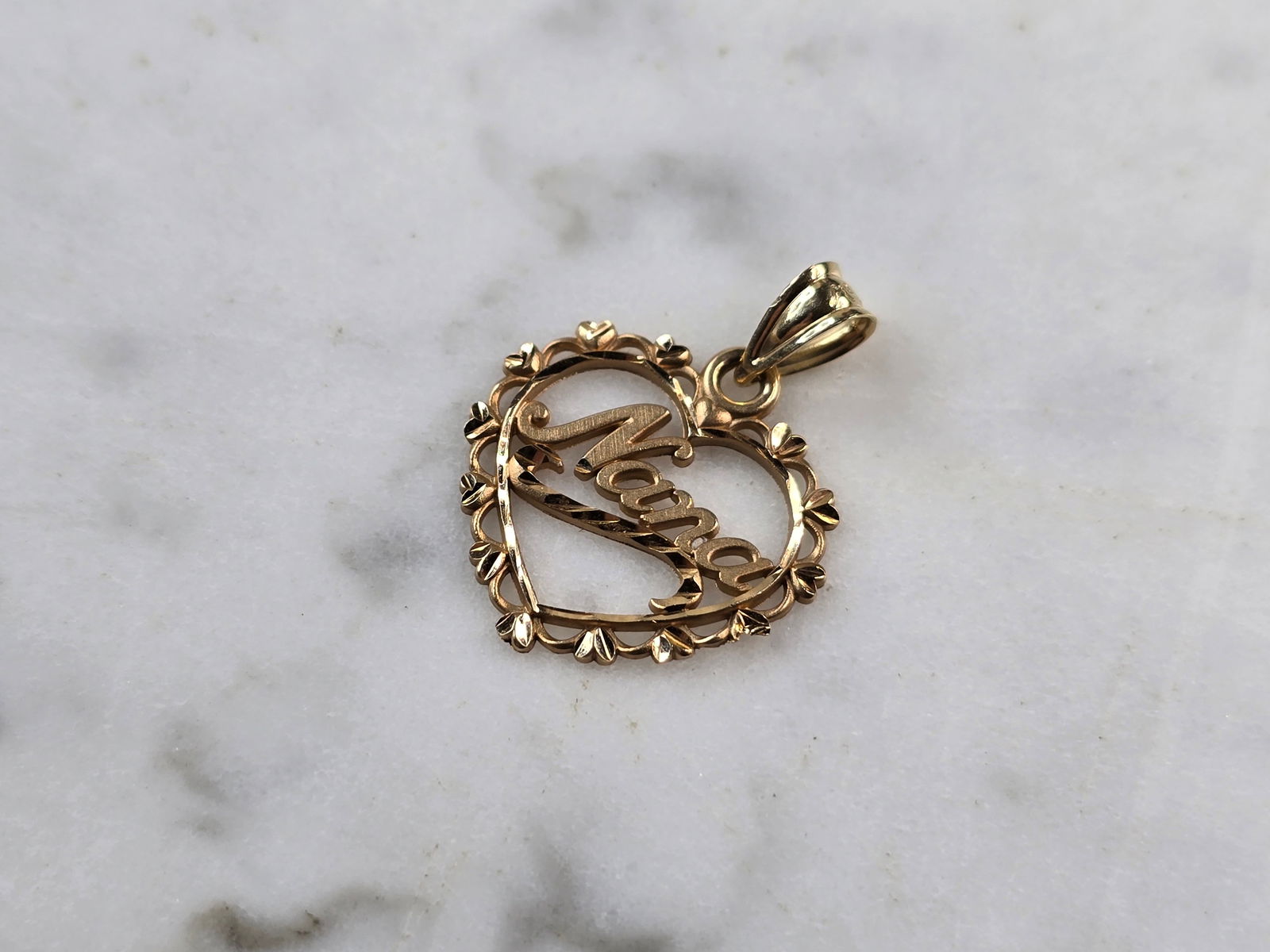 Womens Vintage 14k Gold Michael Anthony Nana Love Heart Pendant: A WOMENS VINTAGE ESTATE 14K GOLD "NANA" LOVE HEART PENDANT MADE BY MICHAEL ANTHONY. THE TOTAL WEIGHT IS 0.9g. THE PENDANT MEASURES 3/4" LONG BY 5/8" WIDE. PENDANT IS MARKED ON THE BACK. MAKES A GREAT
