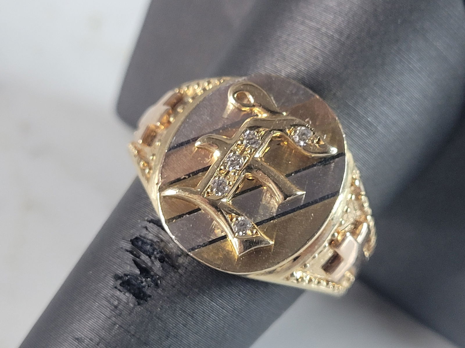 Mens Vintage Estate 14K Multi Gold Religious Cross "E" Diamond Ring: A MENS VINTAGE ESTATE 14K MULTI TONE GOLD RELIGIOUS CROSS RING WITH THE LETTER "E" ON THE FACE. THE RING SIZE IS A 10.0, AND WEIGHS 8.7g. THE WIDTH OF THE BAND IS ABOUT 5/8", AND HAS ABOUT .05CTS OF D